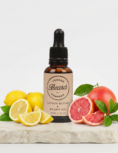 Bottle of London Beard Company Citrus Blend beard oil with lemons and grapefruits on a white background