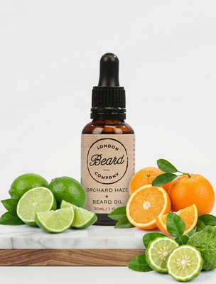 Bottle of London Beard Company beard oil with citrus fruits on a white background