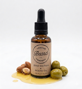 Bottle of London Beard Company beard oil with olives and nuts on a white background